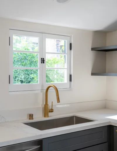 A kitchen with a sink and a window.