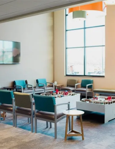 A waiting room with chairs and a television.