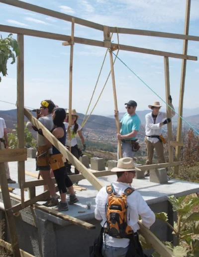 A group of people standing on top of a wooden structure.