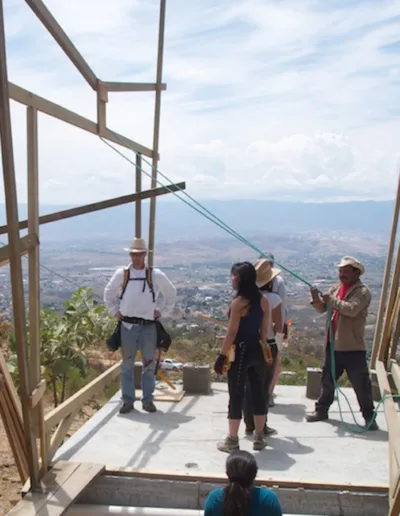 A group of people standing on top of a wooden structure.