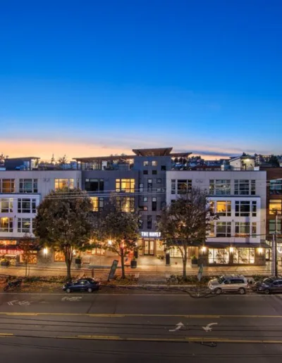 A view of an apartment building at dusk.