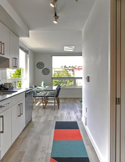 A small kitchen with a bed and a microwave.