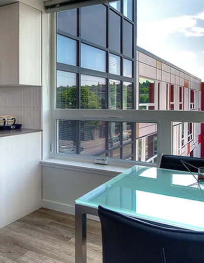 A kitchen and dining area with a view of the city.