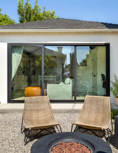 A small backyard with chairs and a fire pit.