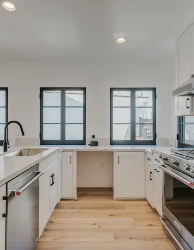 A kitchen with white cabinets and stainless steel appliances.