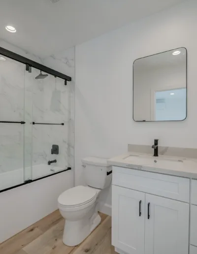 A white bathroom with a toilet and sink.