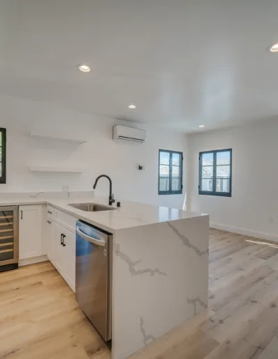 A kitchen with white cabinets and stainless steel appliances.