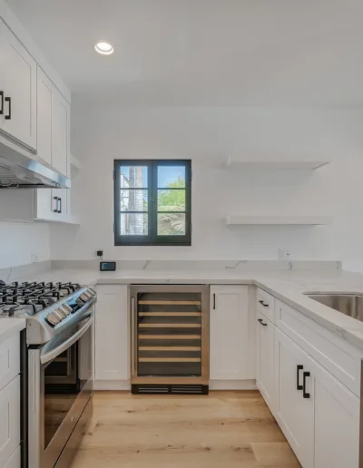 A kitchen with white cabinets and stainless steel appliances.