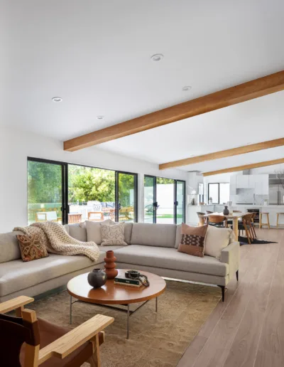 A modern living room with wooden beams.