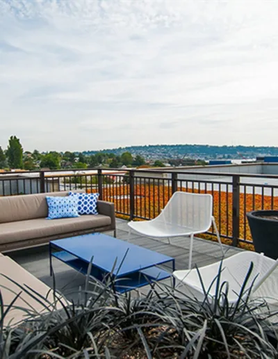 A balcony with furniture and a view of the city.