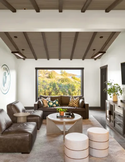 A living room with leather furniture and a tv.