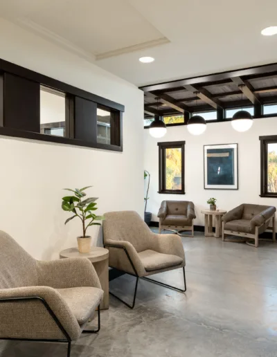 A waiting room with two chairs and a window.