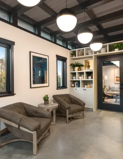 A living room with two chairs and a bookcase.