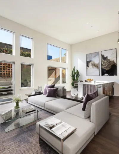 A living room with large windows and sliding glass doors.