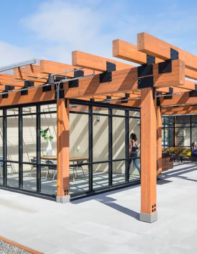 A roofed patio with a wooden pergola.