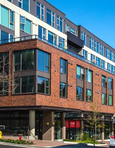 A red brick building on the corner of a street.